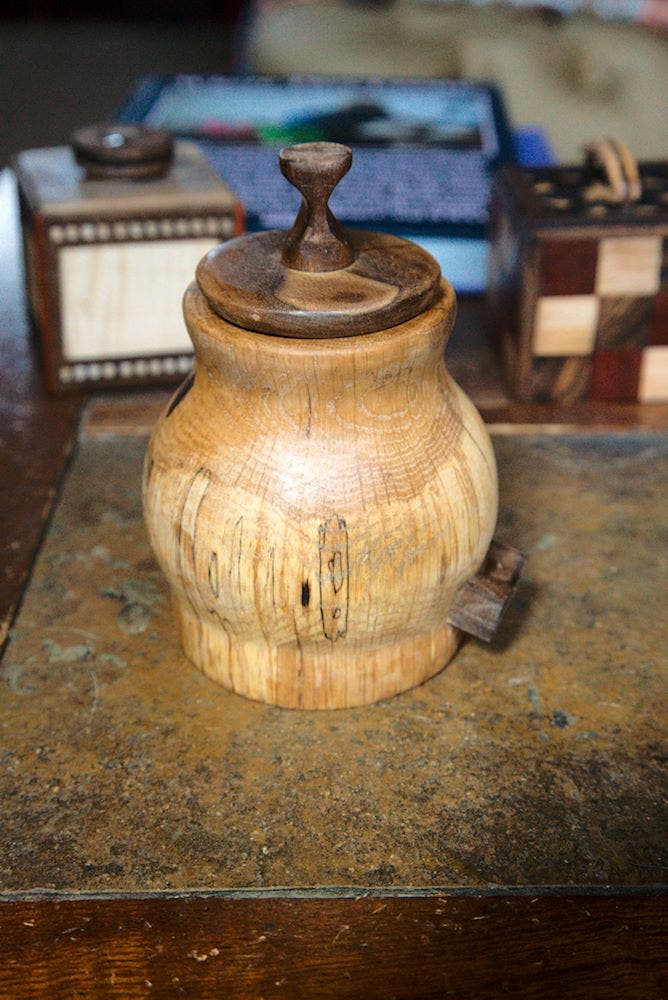 A turned ???pot???, from a spalted oak log, walnut accents